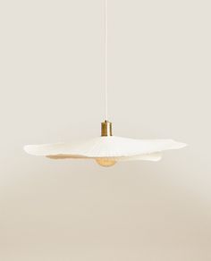 a white light hanging from a ceiling fixture