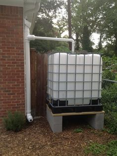 a water tank sitting in front of a brick building