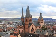 an aerial view of a city with old buildings and steeples in the foreground