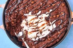 a chocolate cake with ice cream and chocolate chips on top is in a pan, ready to be eaten