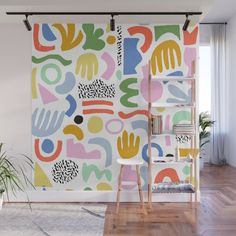 a colorful wall mural with hands and dots in the middle, on a white background