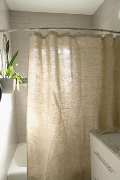 a bathroom with a shower curtain next to a sink