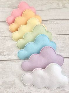 four cloud shaped appliques in pastel colors