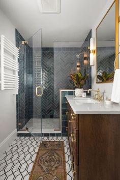 a bathroom with blue tile and gold accents