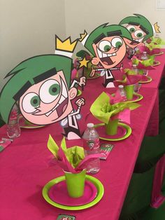 the table is set with pink and green decorations