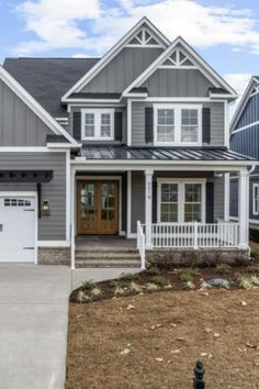 a house with gray siding and white trim