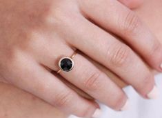 Black onyx 14K gold ring. A dainty, delicate black onyx gemstone ring, ideal for stacking for every woman who loves elegance. An excellent choice for anniversary gift or birthday gift for her. 100% handcrafted with love!D E T A I L S● Metal: 14K solid gold, 14K white gold or 14K rose gold● Gemstone: Black Onyx, briolette cut● Stone Diameter: 8mm (0.31in), 10mm (0.4in) and 12mm (0.5in) R I N G ∙ S I Z I N GFor General Reference:● we use standard US Ring Sizing● an average women's ring finger is s Faceted Round Onyx Jewelry, Everyday Round Onyx Jewelry, Dainty Black Ring Jewelry, Minimalist Black Enamel Jewelry For Anniversary, Minimalist Black Faceted Jewelry, Elegant Black Jewelry Band, Black 14k Gold Band, Black Fine Jewelry Rings For Everyday, Elegant Black Round Band Jewelry