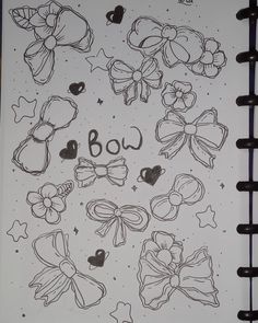 an open notebook with drawings of bows and the word boo written in black ink on it