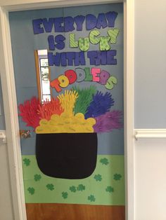 a door decorated with the words every day is lucky with the pot of gold and shamrocks