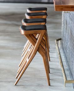 four wooden chairs sitting next to each other