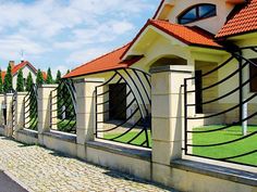 a row of houses sitting next to each other on top of a lush green field