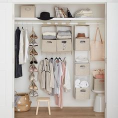 an organized closet with clothes, shoes and other items on shelves in the corner between two doors