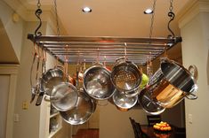 pots and pans hanging from a rack in a kitchen