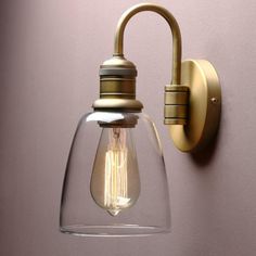 a wall light with a glass shade on it's side and a metal arm