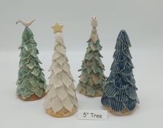 three ceramic christmas trees are shown in front of a sign that says 5 tree on it