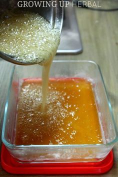 a person pouring liquid into a glass container