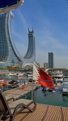 a boat dock with boats and buildings in the background