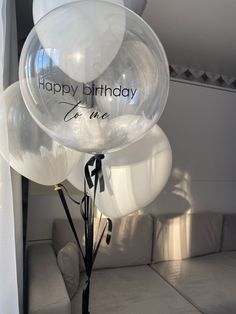 a bunch of balloons that say happy birthday to me on them in front of a couch