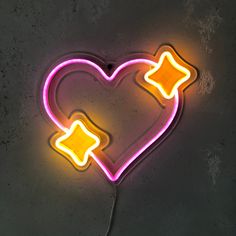 a heart shaped neon sign with two arrows