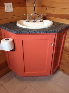 a bathroom with a sink and toilet paper