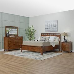 a bed room with a neatly made bed and dressers