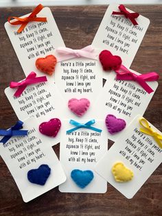 four cards with different colored hearts on them and some words written in white paper next to each other