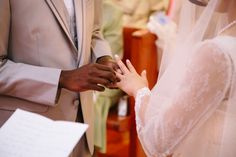 a bride and groom holding hands during a wedding ceremony