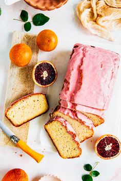 slices of cake with blood oranges on the side and other fruit next to it