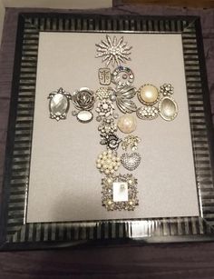 a cross made out of buttons and pearls