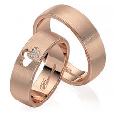 two rose gold wedding rings with diamond hearts