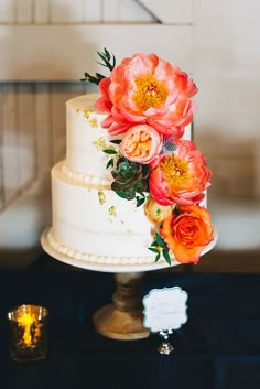 a white wedding cake with flowers on top