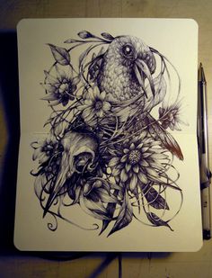 a drawing of a bird and flowers on a white paper with a pen next to it