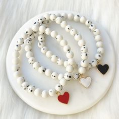 A pretty, lightweight stretch bracelet. Uniquely crafted with 6mm black & white spotted beads and accented with a black, white or red heart charm.  This listing is for ONE bracelet - there are 3 options to choose from.  This bracelet stretches to fit small to medium sized wrists (approximately 7 inches long). Size customization available free of charge - leave your desired dimensions in the comment section with your order.  Please email me with any questions: sarahndipityjewelry@gmail.com Bracelet Valentines, Homemade Bracelets, Jewelry Making Bracelet, Beaded Jewellery, Jewelry Beaded, Bead Charm Bracelet, Lovely Jewellery, Heart Bracelet