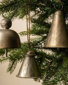 two bells hanging from a christmas tree