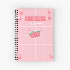 a pink notebook with two strawberries on the front and japanese writing in english,