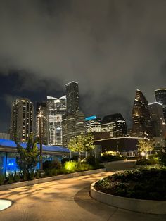 the city skyline is lit up at night