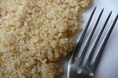 a white plate topped with rice next to a fork