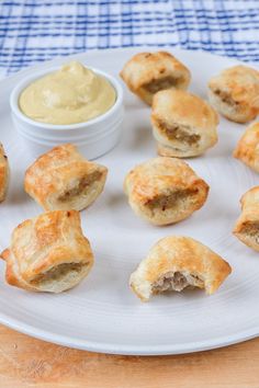 small pastries on a white plate with dipping sauce