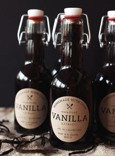 three bottles of vanilla syrup sitting on top of a table