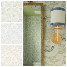 a bathroom with green and blue wallpaper next to a mirror