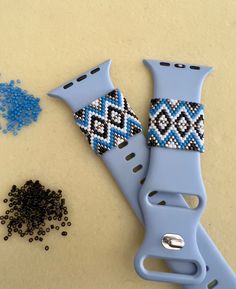 two pieces of beaded fabric sitting next to each other on top of a table