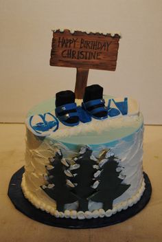 a birthday cake with blue and white frosting