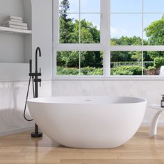 a large white bath tub sitting next to a window