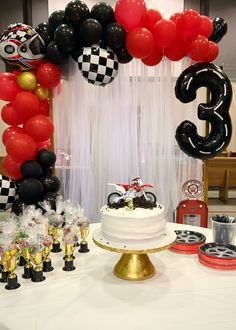 a birthday party with balloons, cake and decorations