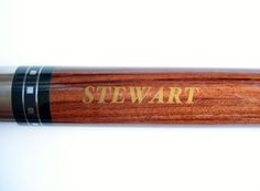 a wooden cue with the word stewart written on it