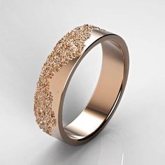 a wedding ring with gold glitters on the outside and inside, against a white background