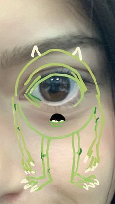 a girl with green lines drawn on her face and an eye looking at the camera