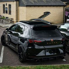 two cars parked in a parking lot next to each other