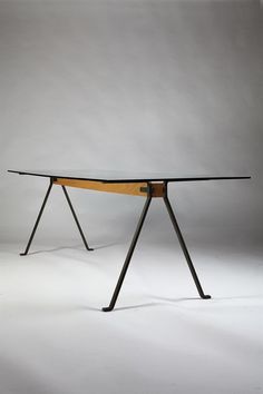 the table is made out of wood and has two legs that are bent to one side