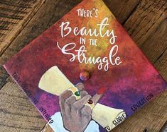 there's beauty in the struggle book on a wooden table